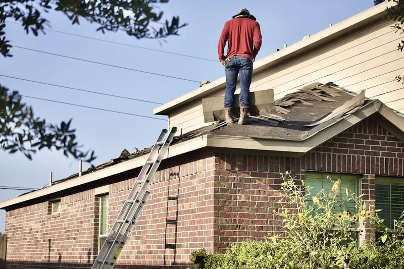Professional roofer working on a residential roof in New Centerville